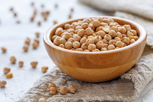 Bowl of chickpeas so full that some are overflowing