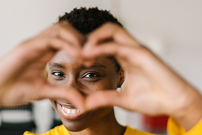 woman making heart sign with her hands