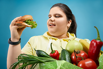 overweight woman eating a healthy sandwich