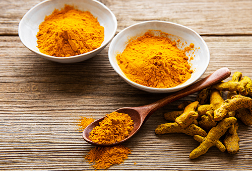 bowl of turmeric powder on a table