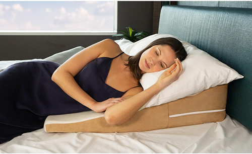 woman sleeping sideways on an wedge pillow