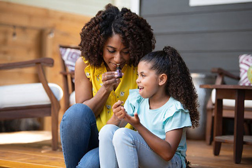 mother and daughter enjoying the smell of essential oil