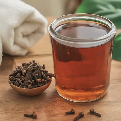 glass filled with mouthwash made using cloves