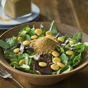 bowl of a salad topped with toasted and ground lupine
