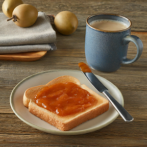 a plate with a sandwich covered with sapote preserves
