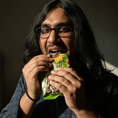 a man eating sunflower seeds that is rich in calcium