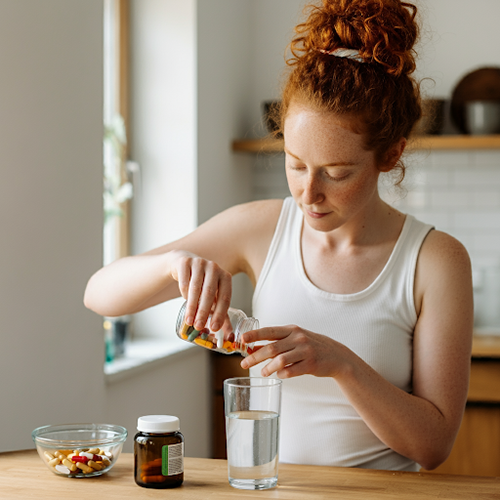 Woman taking b complex vitamins