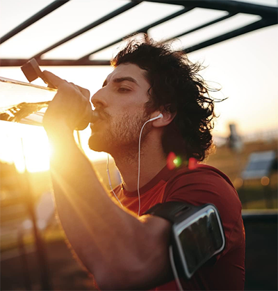 a man drinking water from a bottle